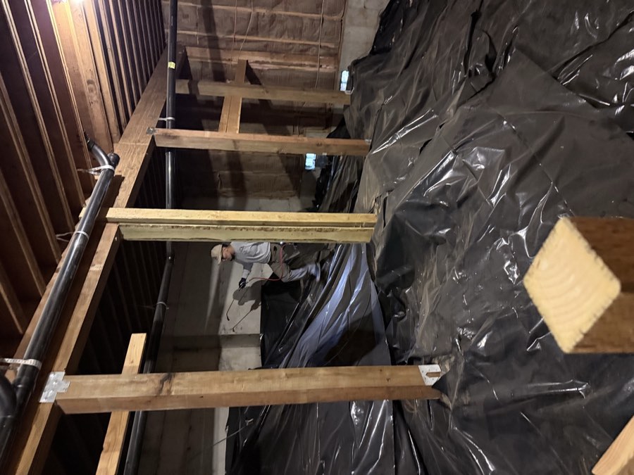 Affordable Pest Pros technician inspecting and treating an accessible crawlspace